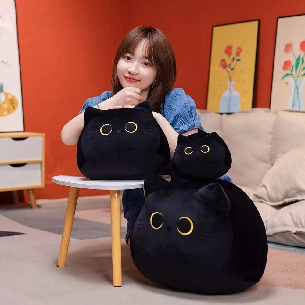 Three different black cat plushies